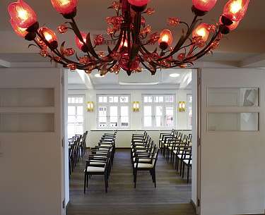 001 tagen Meeting room in cinema seating with red chandelier in the foreground
